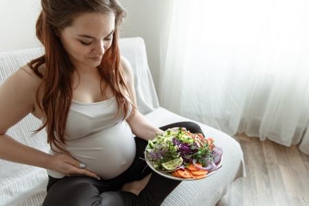 expectant-mother-last-months-pregnancy-is-holding-plate-vegetable-salad