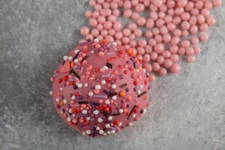 One pink sweet doughnut with sprinkles